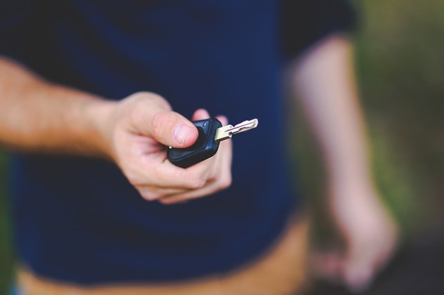 Man holding a car key
