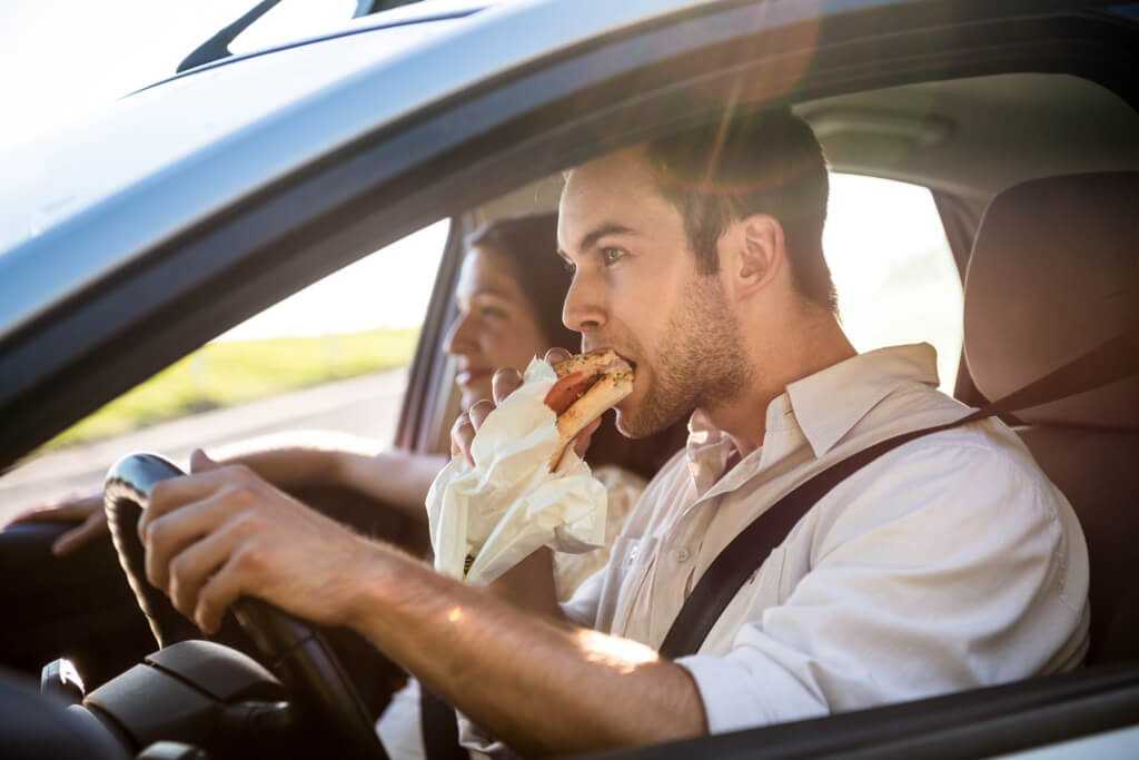 man eating whilst driving